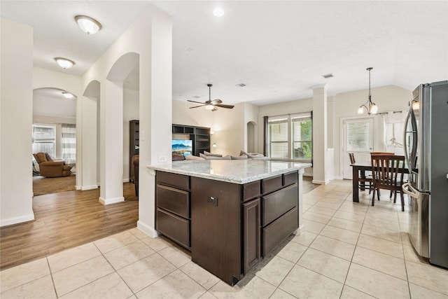 12747 Bridle Springs Ln, Houston, TX 77044 - kitchen featuring freestanding refrigerator, open floor plan, dark brown cabinetry, a ceiling fan, and plenty of natural light