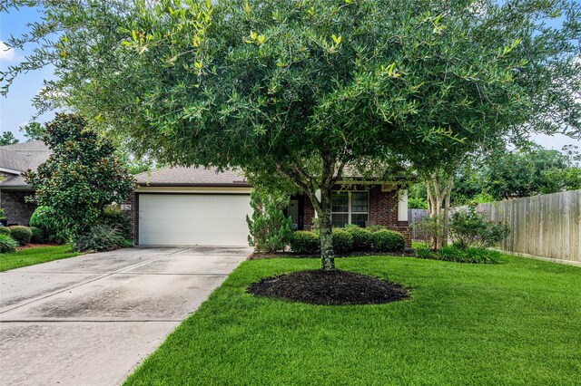12747 Bridle Springs Ln, Houston, TX 77044 - obstructed view of property with a garage, brick siding, and concrete driveway