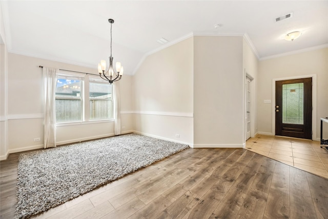12747 Bridle Springs Ln, Houston, TX 77044 - foyer with a chandelier, wood finished floors, ornamental molding, and lofted ceiling