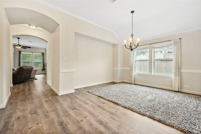 12747 Bridle Springs Ln, Houston, TX 77044 - unfurnished dining area featuring wood finished floors, crown molding, a chandelier, vaulted ceiling, and arched walkways