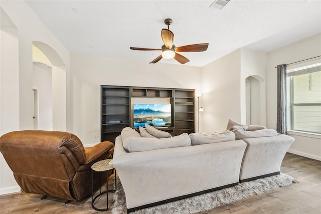 12747 Bridle Springs Ln, Houston, TX 77044 - living room with ceiling fan, wood finished floors, and arched walkways