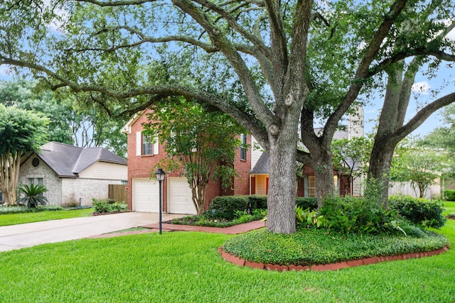 902 Mesa Terrace Dr, Katy, TX 77450 - view of front of house featuring an attached garage, concrete driveway, a front lawn, and brick siding