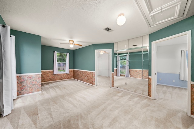 902 Mesa Terrace Dr, Katy, TX 77450 - unfurnished bedroom with attic access, wainscoting, carpet floors, and a textured ceiling