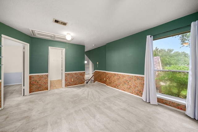 902 Mesa Terrace Dr, Katy, TX 77450 - carpeted empty room featuring attic access, healthy amount of natural light, and a textured ceiling