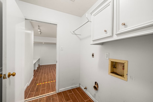 902 Mesa Terrace Dr, Katy, TX 77450 - laundry area featuring cabinet space, washer hookup, wood finish floors, gas dryer hookup, and electric dryer hookup
