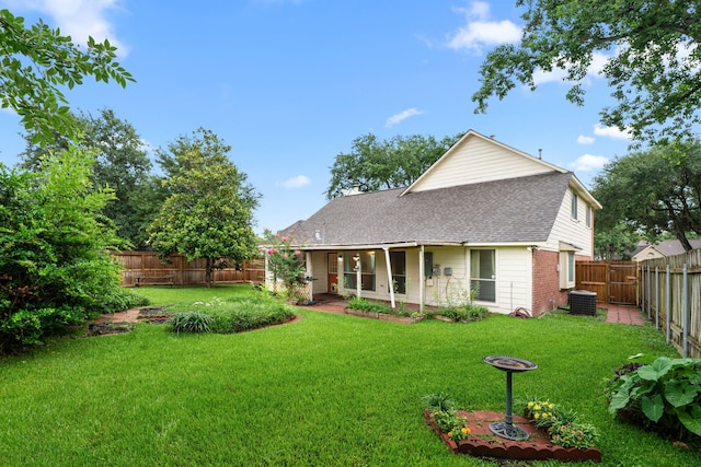 902 Mesa Terrace Dr, Katy, TX 77450 - rear view of property featuring a shingled roof, a fenced backyard, brick siding, and a chimney