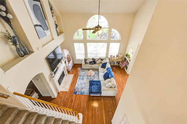 24811 Corbin Gate Dr, Spring, TX 77389 - living area featuring a ceiling fan, wood finished floors, a high ceiling, and stairway