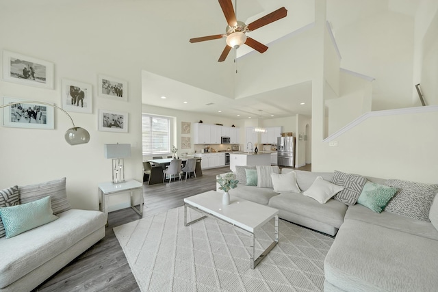 2810 Parkside Village Ln, Pearland, TX 77581 - living area featuring light wood-style flooring, ceiling fan, and a towering ceiling