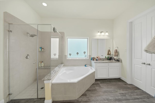 2810 Parkside Village Ln, Pearland, TX 77581 - full bathroom with a bath, vanity, a shower stall, and wood finished floors