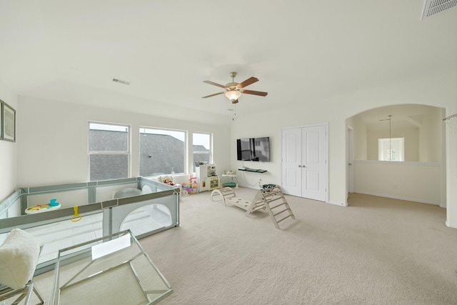 2810 Parkside Village Ln, Pearland, TX 77581 - living room with ceiling fan, carpet floors, and arched walkways