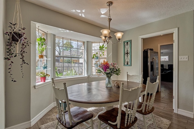 24203 Creekview Dr, Spring, TX 77389 - dining area featuring a chandelier, wood finished floors, and a textured ceiling