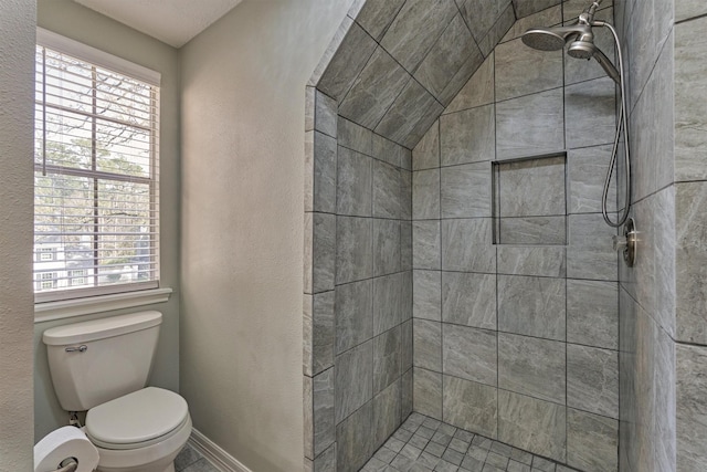 24203 Creekview Dr, Spring, TX 77389 - full bath with a tile shower, healthy amount of natural light, and a textured wall