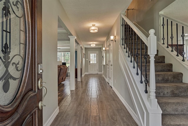 24203 Creekview Dr, Spring, TX 77389 - foyer featuring dark wood-type flooring, a textured ceiling, and stairs