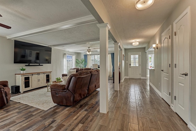 24203 Creekview Dr, Spring, TX 77389 - entryway with ceiling fan, a textured ceiling, wood finished floors, ornate columns, and beam ceiling