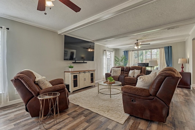 24203 Creekview Dr, Spring, TX 77389 - living room featuring a ceiling fan, a textured ceiling, wood finished floors, ornamental molding, and beam ceiling