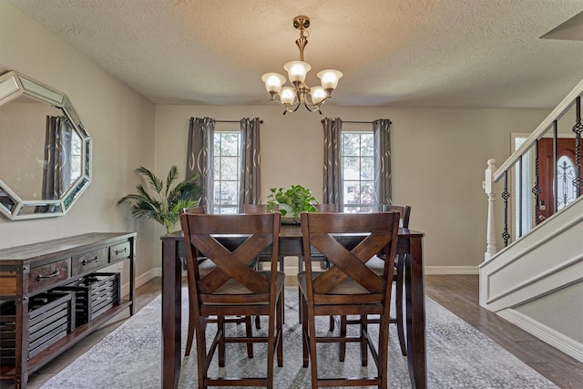 24203 Creekview Dr, Spring, TX 77389 - dining space with a chandelier, a textured ceiling, stairway, and wood finished floors