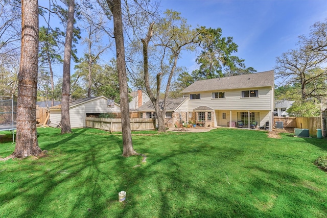 24203 Creekview Dr, Spring, TX 77389 - rear view of property with a trampoline, a fenced backyard, and a patio