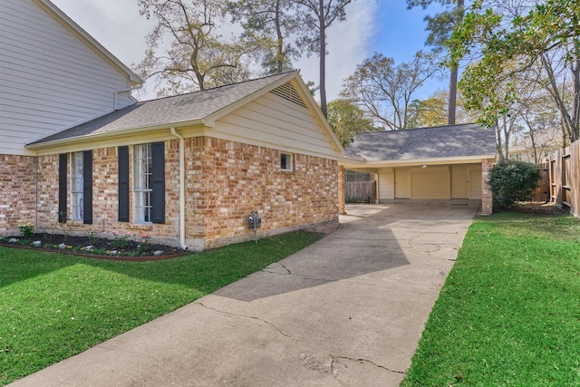24203 Creekview Dr, Spring, TX 77389 - view of side of home with brick siding, driveway, roof with shingles, and a carport