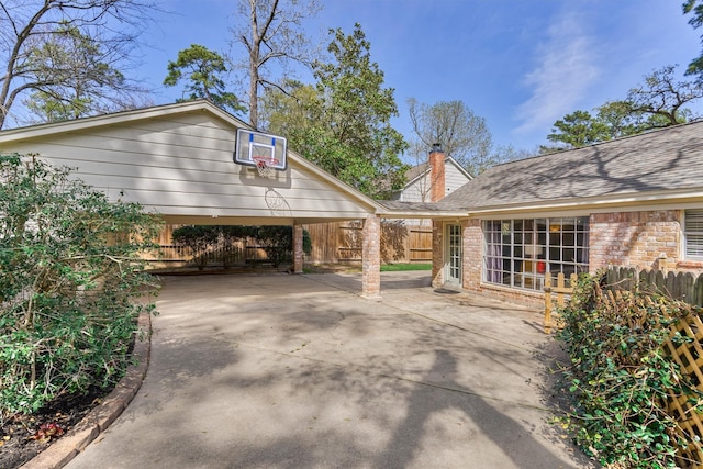 24203 Creekview Dr, Spring, TX 77389 - view of home's exterior featuring concrete driveway, a chimney, and brick siding