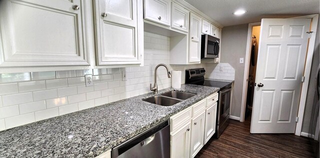 14777 Wunderlich Dr Unit 605, Houston, TX 77069 - kitchen featuring appliances with stainless steel finishes, white cabinets, light stone countertops, dark wood-type flooring, and decorative backsplash
