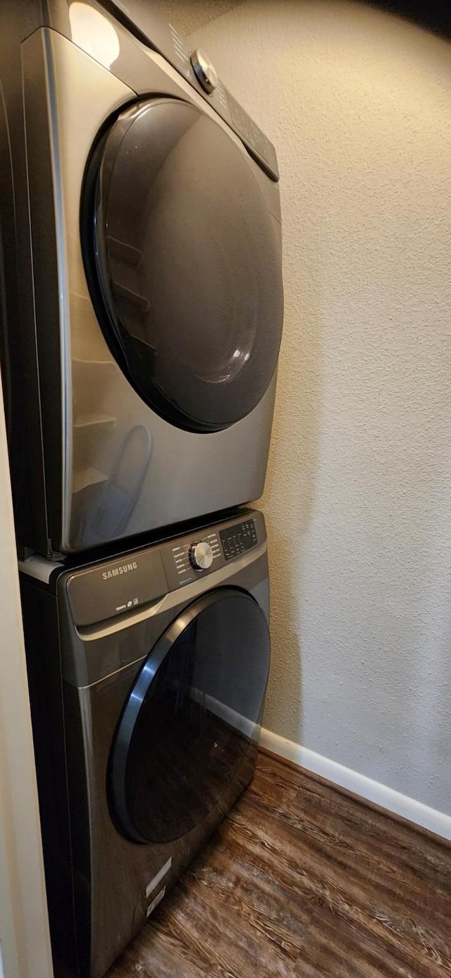 14777 Wunderlich Dr Unit 605, Houston, TX 77069 - laundry area featuring stacked washer / drying machine and wood finished floors