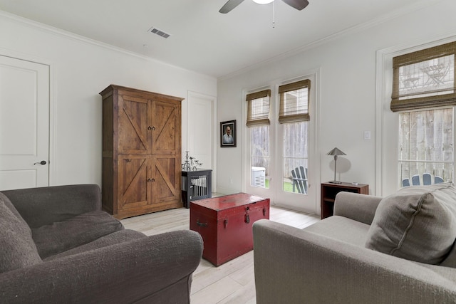 5218 Crawford St, Houston, TX 77004 - living room featuring plenty of natural light, a ceiling fan, ornamental molding, and light wood-style flooring