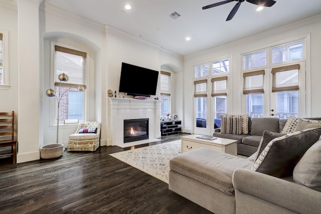 5218 Crawford St, Houston, TX 77004 - living room with ornamental molding, ceiling fan, a fireplace with flush hearth, dark wood-type flooring, and recessed lighting
