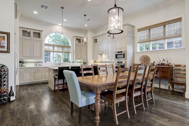 5218 Crawford St, Houston, TX 77004 - dining area with dark wood-style flooring, ornamental molding, and recessed lighting