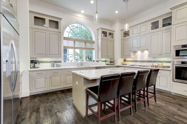 5218 Crawford St, Houston, TX 77004 - kitchen with stainless steel appliances, ornamental molding, a center island, tasteful backsplash, and recessed lighting