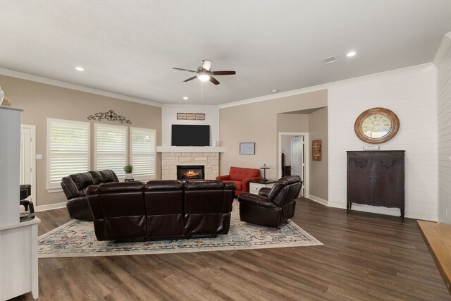 1803 Twin Oaks Cir, Brenham, TX 77833 - living room with a stone fireplace, ceiling fan, dark wood-style floors, recessed lighting, and crown molding