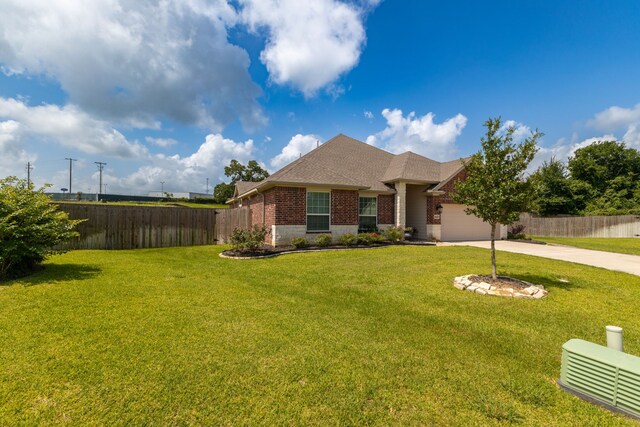 1803 Twin Oaks Cir, Brenham, TX 77833 - view of front facade featuring brick siding, concrete driveway, an attached garage, and a shingled roof