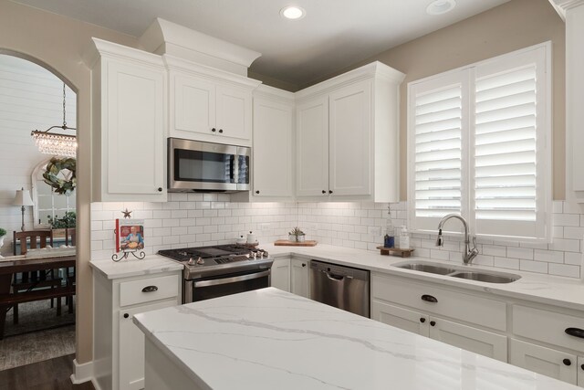 1803 Twin Oaks Cir, Brenham, TX 77833 - kitchen with appliances with stainless steel finishes, white cabinetry, decorative backsplash, light stone counters, and recessed lighting