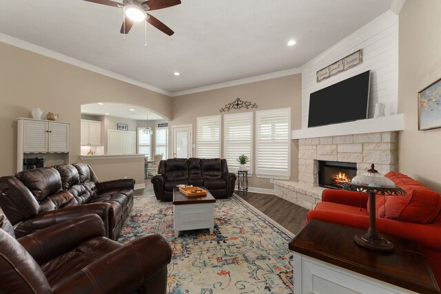 1803 Twin Oaks Cir, Brenham, TX 77833 - living area with a ceiling fan, wood finished floors, a stone fireplace, recessed lighting, and crown molding