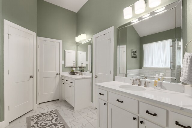 1803 Twin Oaks Cir, Brenham, TX 77833 - bathroom with marble look tile flooring, two vanities, and lofted ceiling