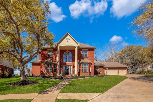 210 River Oaks Dr, Lake Jackson, TX 77566 - neoclassical / greek revival house with a front lawn, concrete driveway, brick siding, and a garage