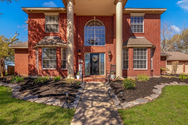 210 River Oaks Dr, Lake Jackson, TX 77566 - view of front of home featuring brick siding and a front yard