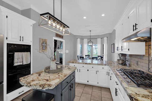210 River Oaks Dr, Lake Jackson, TX 77566 - kitchen with stainless steel gas stovetop, under cabinet range hood, white cabinets, recessed lighting, and a peninsula