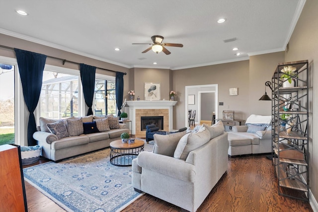 210 River Oaks Dr, Lake Jackson, TX 77566 - living room featuring dark wood finished floors, a ceiling fan, a fireplace, crown molding, and recessed lighting