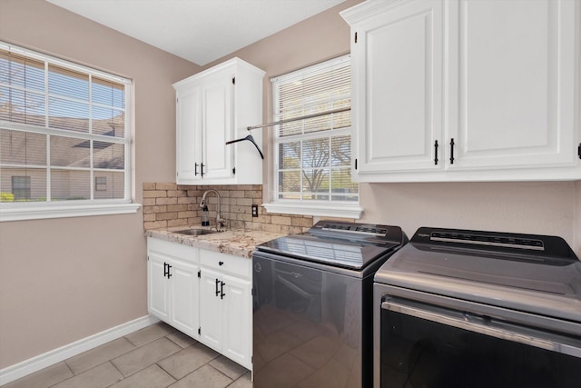 210 River Oaks Dr, Lake Jackson, TX 77566 - laundry area featuring washing machine and dryer, light tile patterned flooring, and cabinet space