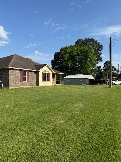 240 Rosalie St, Shepherd, TX 77371 - rear view of property with a yard and brick siding