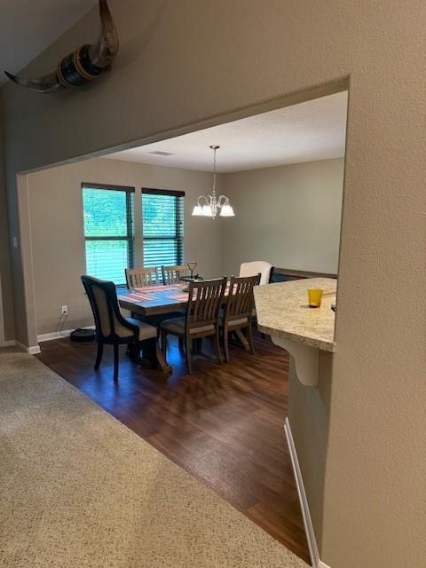 240 Rosalie St, Shepherd, TX 77371 - dining space with a chandelier and dark wood finished floors
