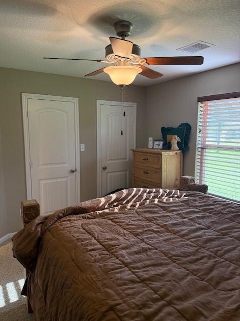 240 Rosalie St, Shepherd, TX 77371 - carpeted bedroom featuring ceiling fan and a textured ceiling