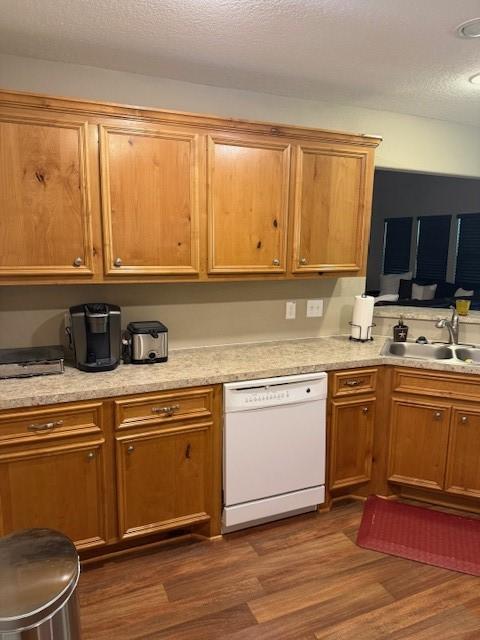 240 Rosalie St, Shepherd, TX 77371 - kitchen featuring dishwasher, dark wood-type flooring, and a textured ceiling
