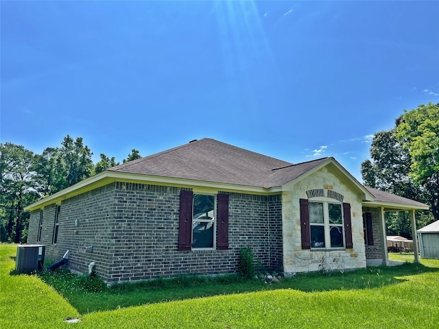 240 Rosalie St, Shepherd, TX 77371 - view of home's exterior with a yard, roof with shingles, and brick siding