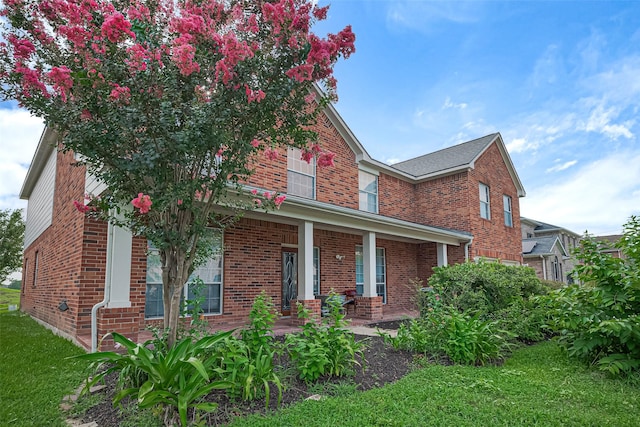 11107 Camino Oaks Dr, Houston, TX 77064 - view of front of house with brick siding, a porch, and a front lawn