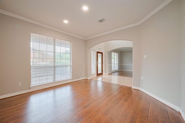 11107 Camino Oaks Dr, Houston, TX 77064 - spare room with arched walkways, light wood-type flooring, crown molding, and recessed lighting