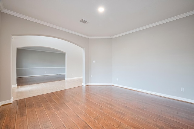 11107 Camino Oaks Dr, Houston, TX 77064 - spare room with ornamental molding, light wood-type flooring, and arched walkways