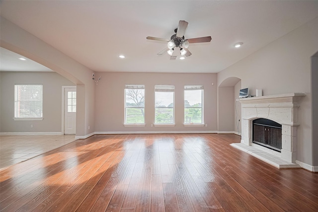 11107 Camino Oaks Dr, Houston, TX 77064 - unfurnished living room with ceiling fan, arched walkways, plenty of natural light, wood-type flooring, and recessed lighting
