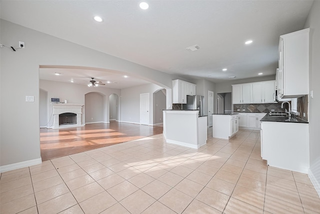 11107 Camino Oaks Dr, Houston, TX 77064 - kitchen featuring stainless steel fridge, open floor plan, light tile patterned flooring, dark countertops, and recessed lighting