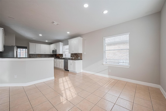 11107 Camino Oaks Dr, Houston, TX 77064 - kitchen with appliances with stainless steel finishes, plenty of natural light, backsplash, dark countertops, and recessed lighting